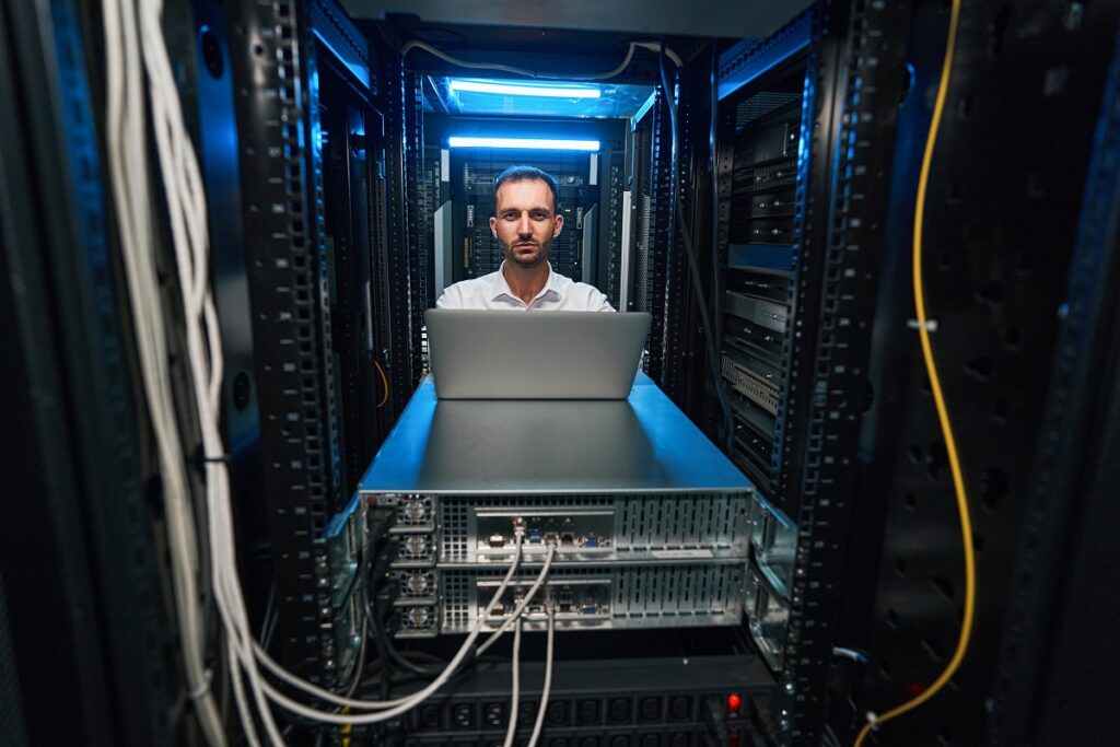 an IT technician checking and monitoring equipment functionalities