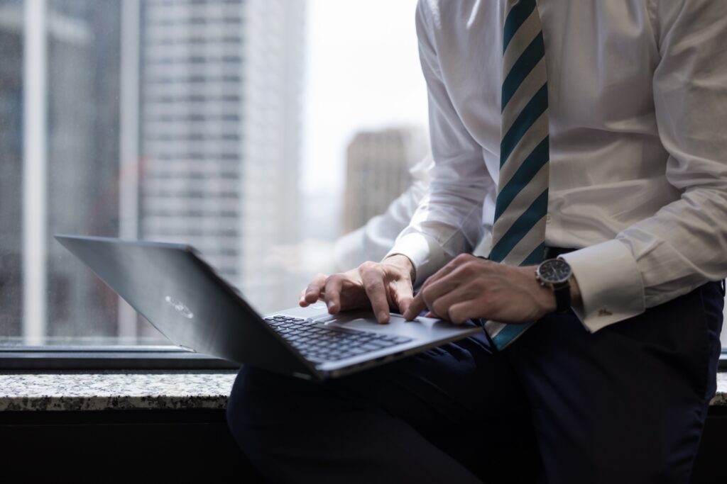 male professional updating his resume on laptop to include introduction paragraph