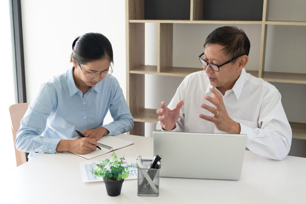 senior professional guiding his intern at work