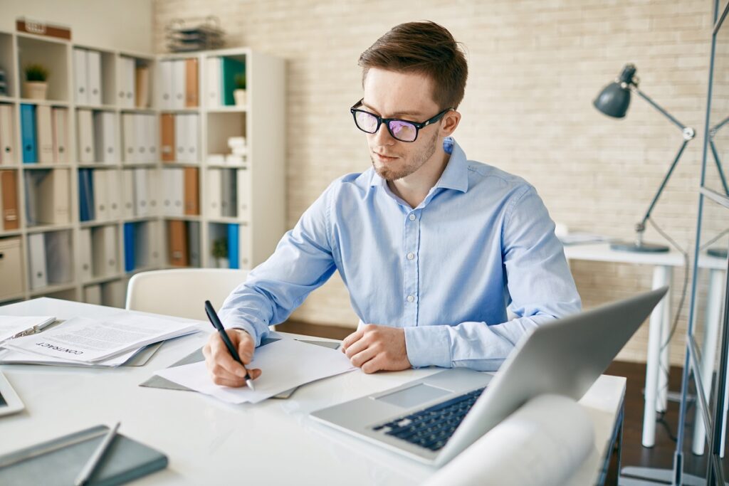 A man writing professional work goals