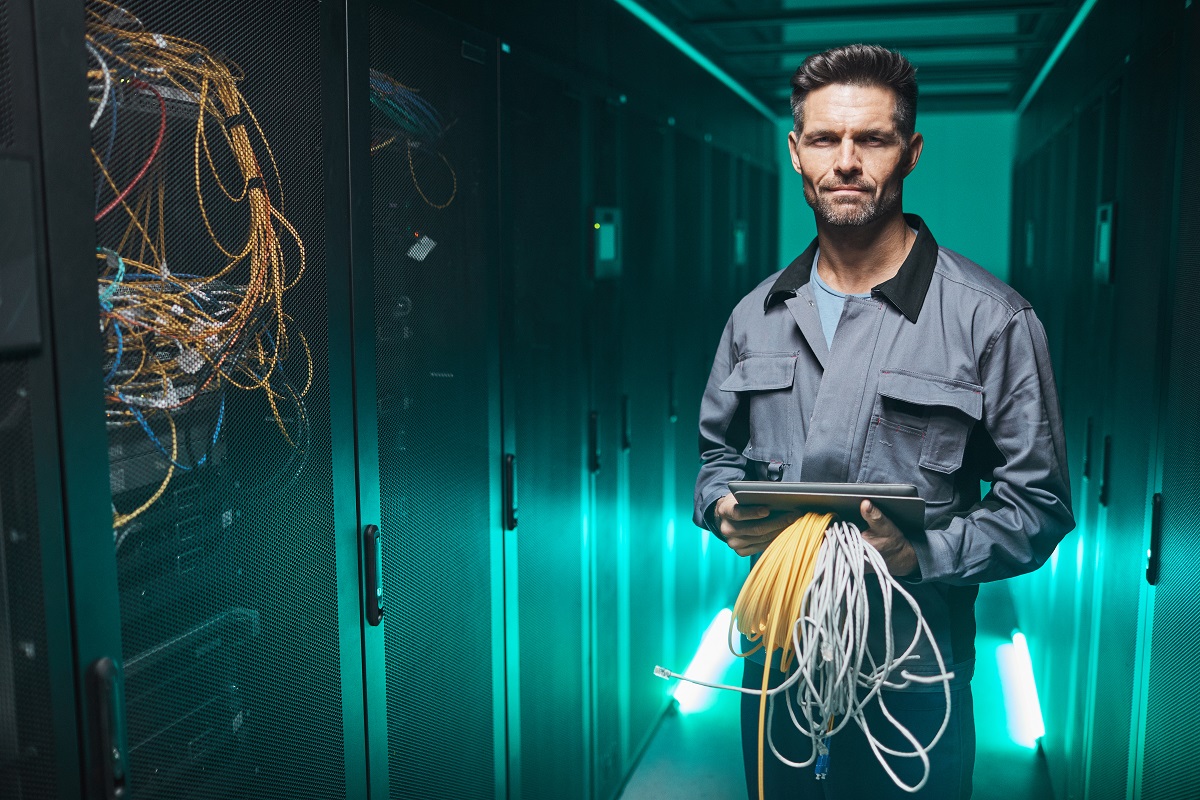 a senior network engineer doing maintenance work in a data center