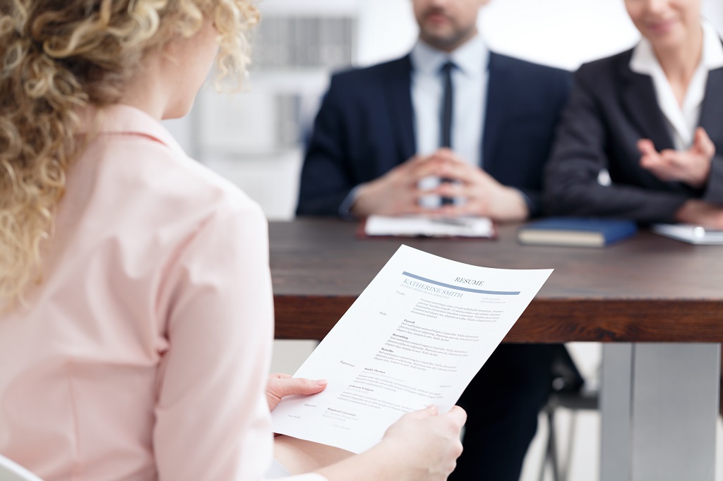 a candidate confidently holding her resume in an interview