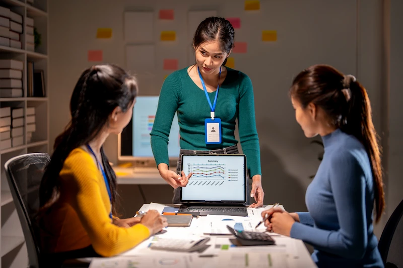 woman mentor guiding two other member